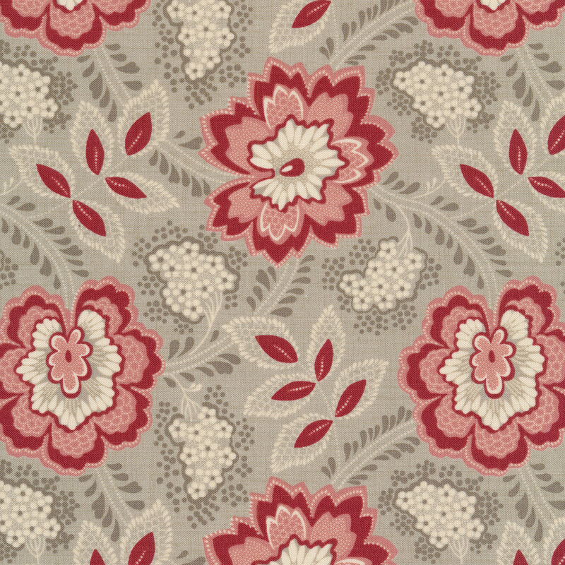 Floral fabric decorated with large pink and red flowers and bunches of small white flowers on a gray background