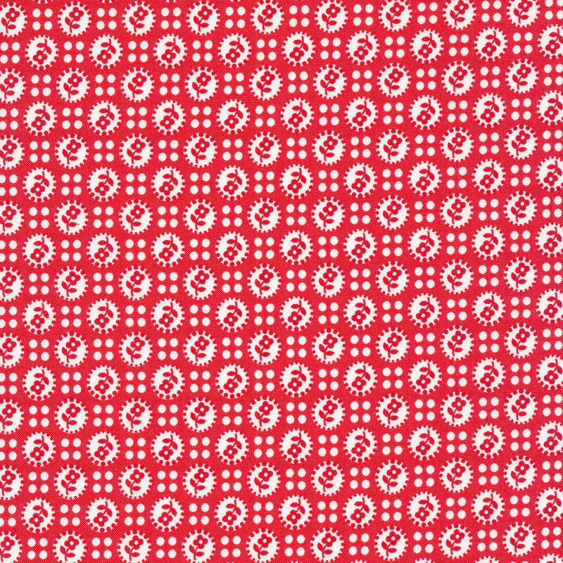 Red fabric covered in white dots with flower silhouettes separated by four small white dots.