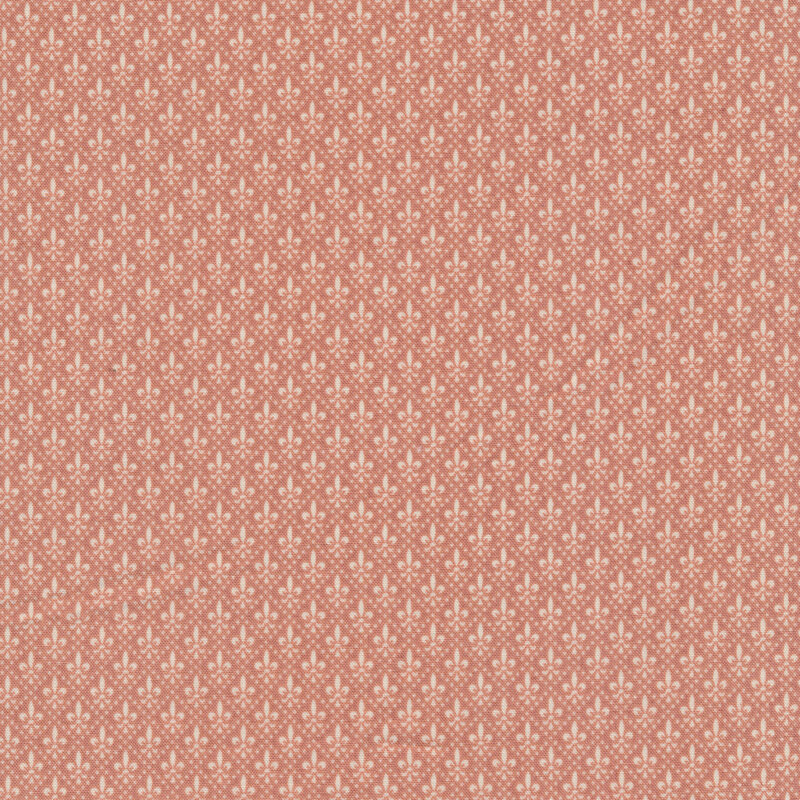 Fabric featuring small cream fleur-de-lis divided by cream dots in a diamond pattern, set against a pink background