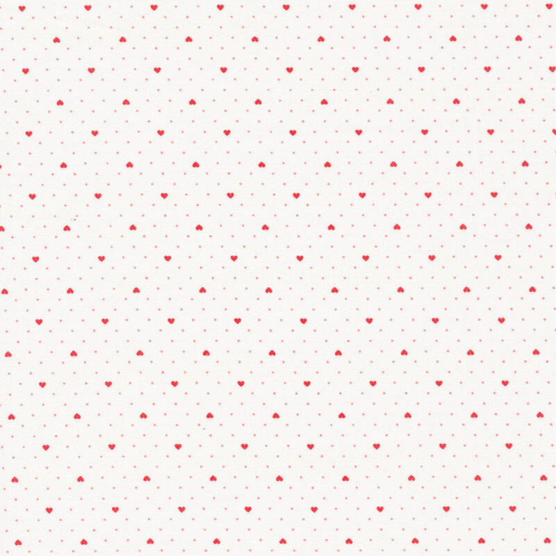 White fabric with tiny pink polka dots all over and evenly spaced small red hearts