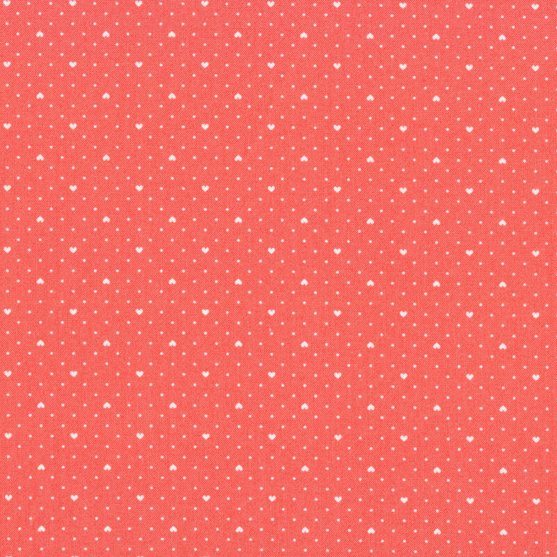 Pink fabric with tiny white polka dots all over and evenly spaced small white hearts