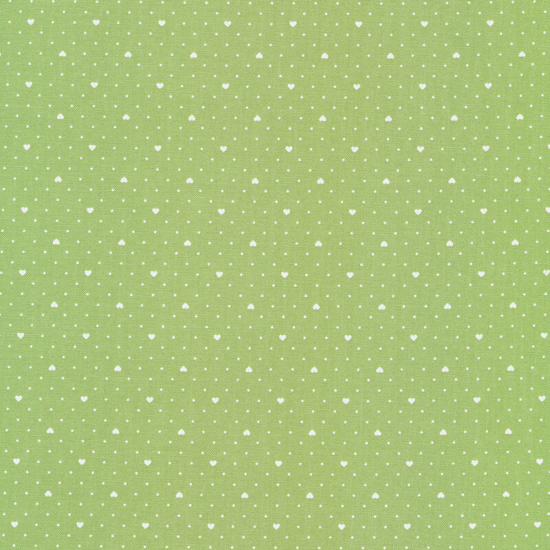 Light green fabric with tiny white polka dots all over and evenly spaced small white hearts