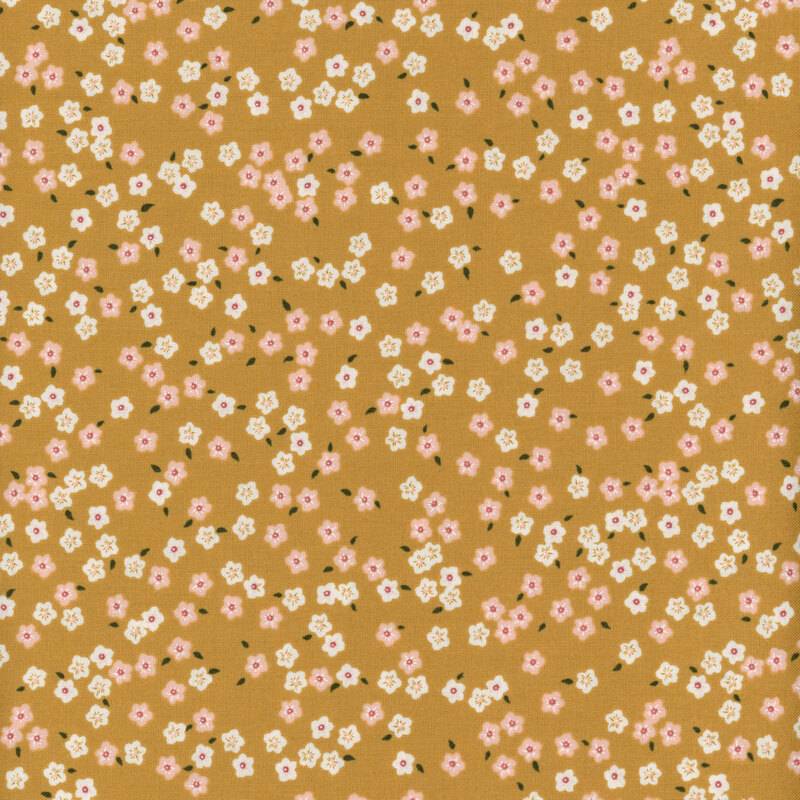 fabric with pink and white ditsy flowers on a warm gold background