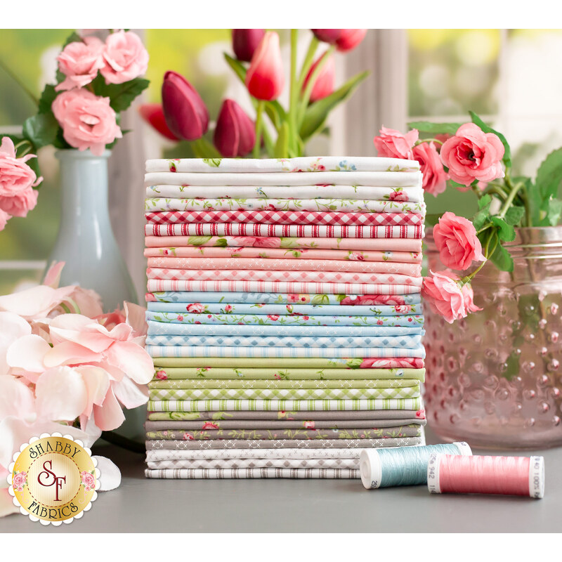 Ellie fat quarter set staged with gorgeous spring flowers and matching thread spools.
