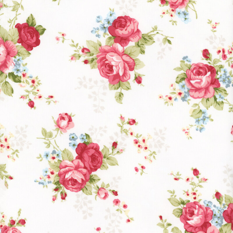 Floral fabric with a light cream background featuring large pink roses and small blue and yellow flowers, accented by rosebuds and lush green leaves