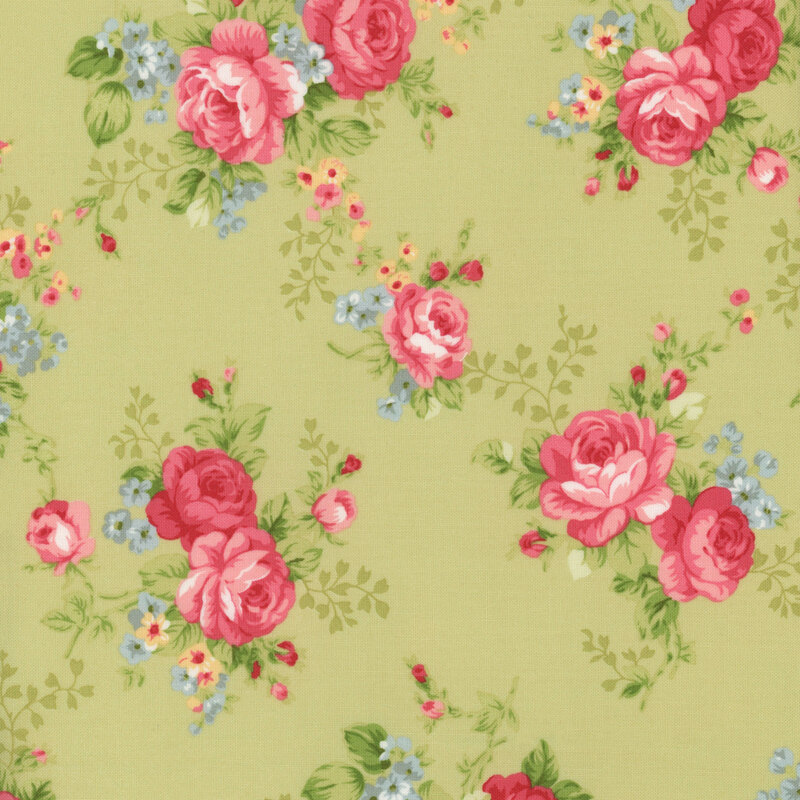 Floral fabric with a light green background featuring large pink roses and small blue and yellow flowers, accented by rosebuds and lush green leaves