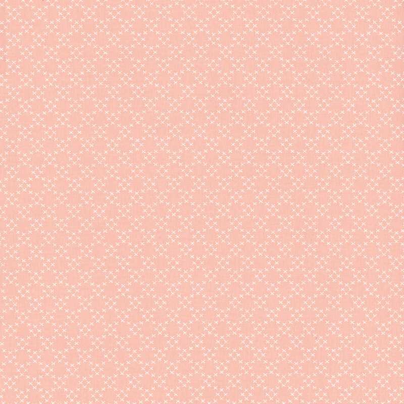 Fabric featuring a trellis pattern consisting of small white X-shapes, set against a light pink background