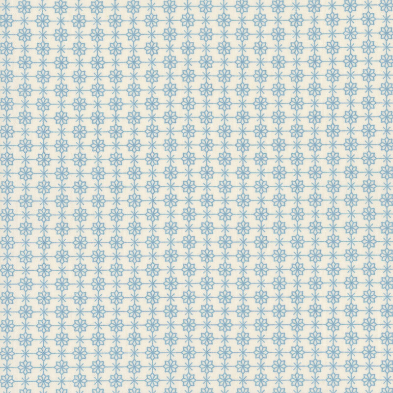 cream fabric featuring a compelling geometric blue grid with flowers and Xs alternating at each corner
