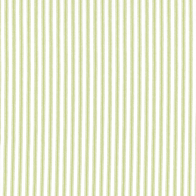 Fabric featuring green stripes set against a light cream background