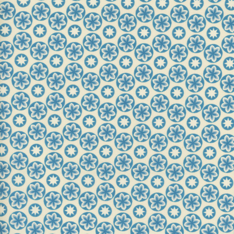 fabric featuring a light blue circular design, each circle containing blue and cream accented flowers and stars
