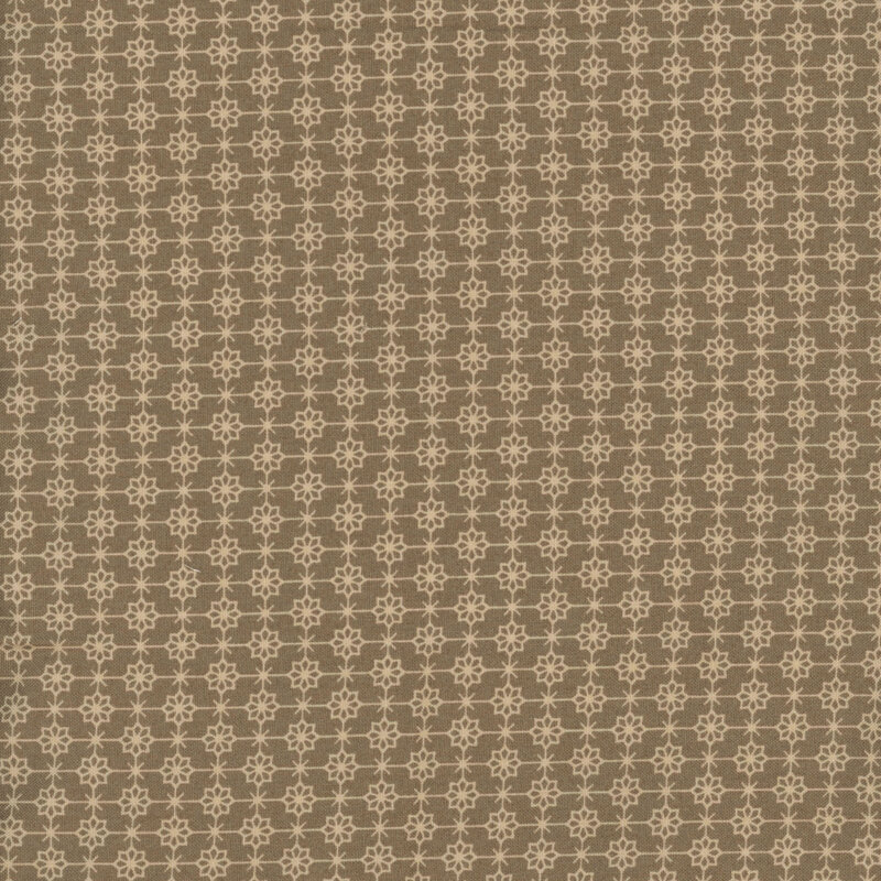 brown fabric featuring a compelling geometric tan grid with flowers and Xs alternating at each corner