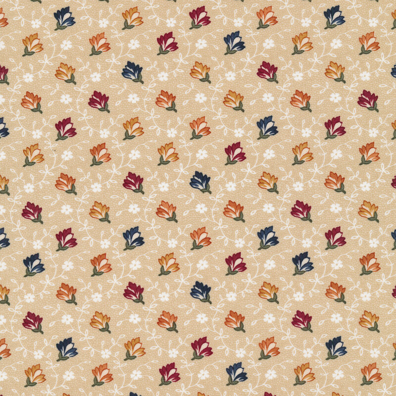 Fabric with red, blue and yellow flowers with white vines and blossoms on a tan background.