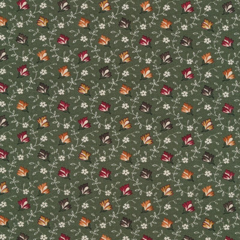 Fabric that features green, red and yellow flowers with white vines and blossoms on a dark green background.