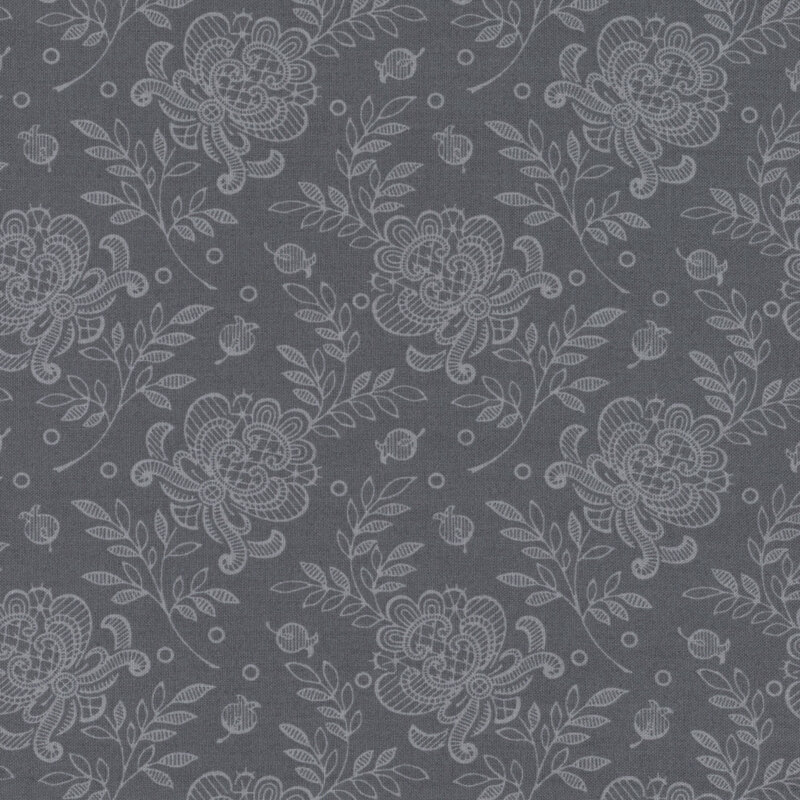 Image of fabric decorated with lacy tonal floral prints set against a gray background