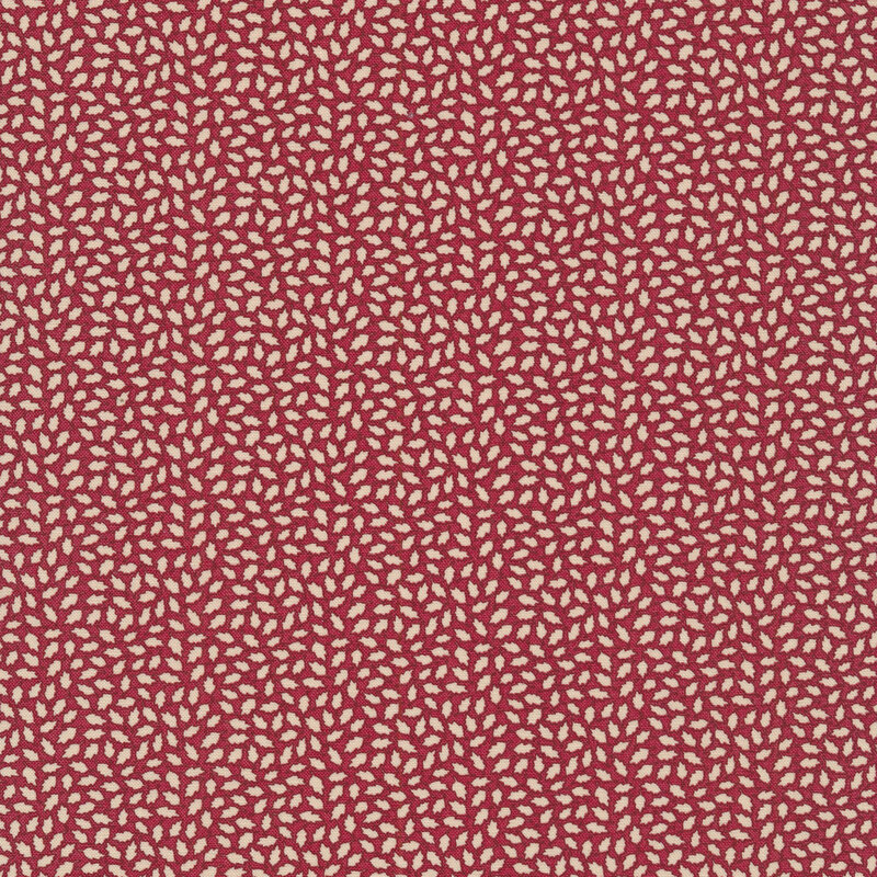Fabric that features a lovely cream-colored leaf print on a dark maroon red background