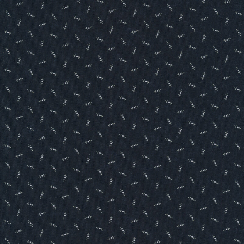 Fabric that features tossed cream motifs on a mottled dark navy blue background.