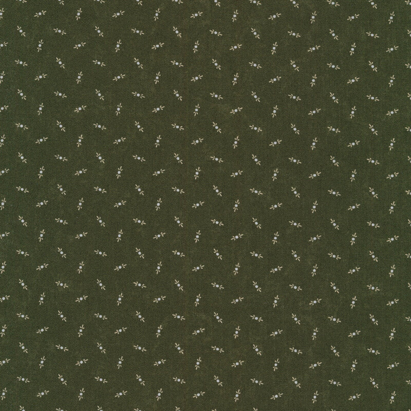 Fabric that features tossed cream motifs on a mottled dark green background.