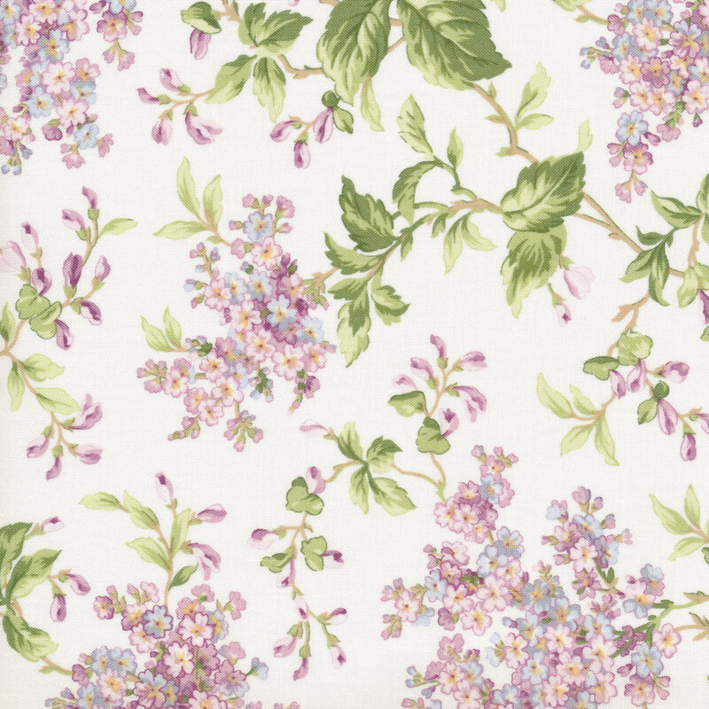 White fabric with pink and purple lilac clusters and green branches across it
