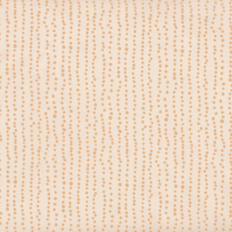 fabric featuring golden tan dots in rows of various sizes on a tan background
