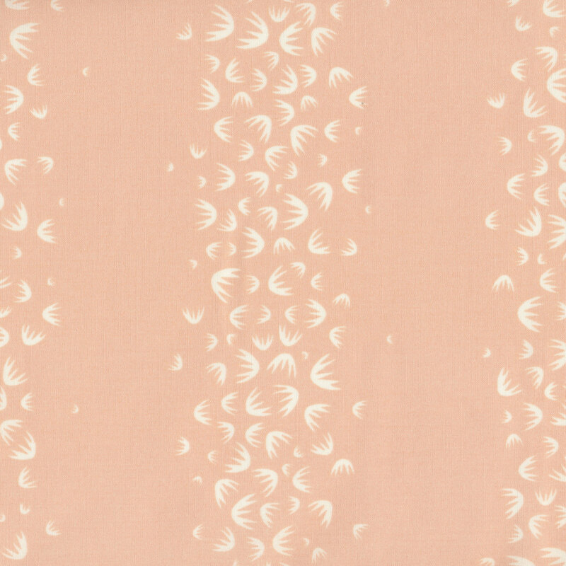 fabric with white palm fronds tossed in stripe patterns on a dusty pink background. 