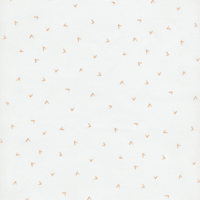 fabric featuring gold ditsy tossed chevrons across an off white background