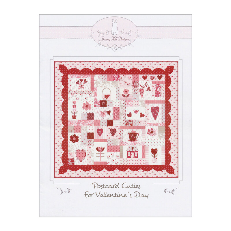 Front of the postcard cuties for valentine's day quilt pattern, showing the finished red and pink quilt, covered in hearts and flowers