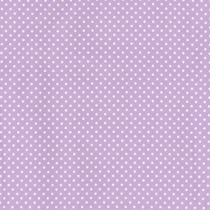 this fabric features a light lilac purple background with white ditsy polka dots