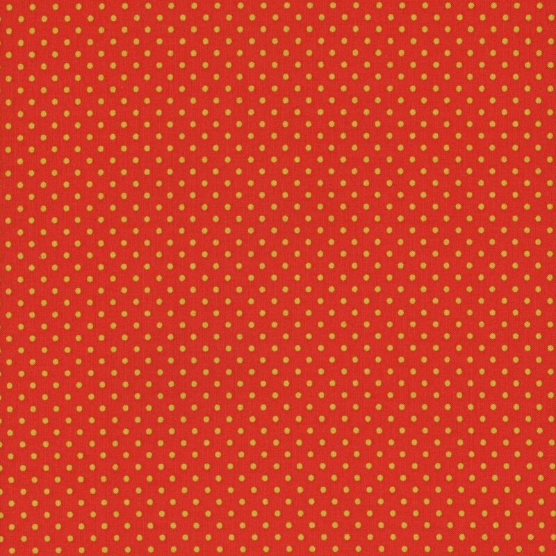 this fabric features a bright orange background with ditsy yellow polka dots
