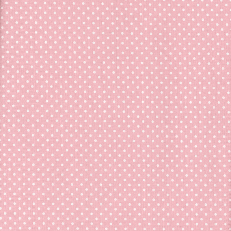This fabric features baby pink background with ditsy white polka dots