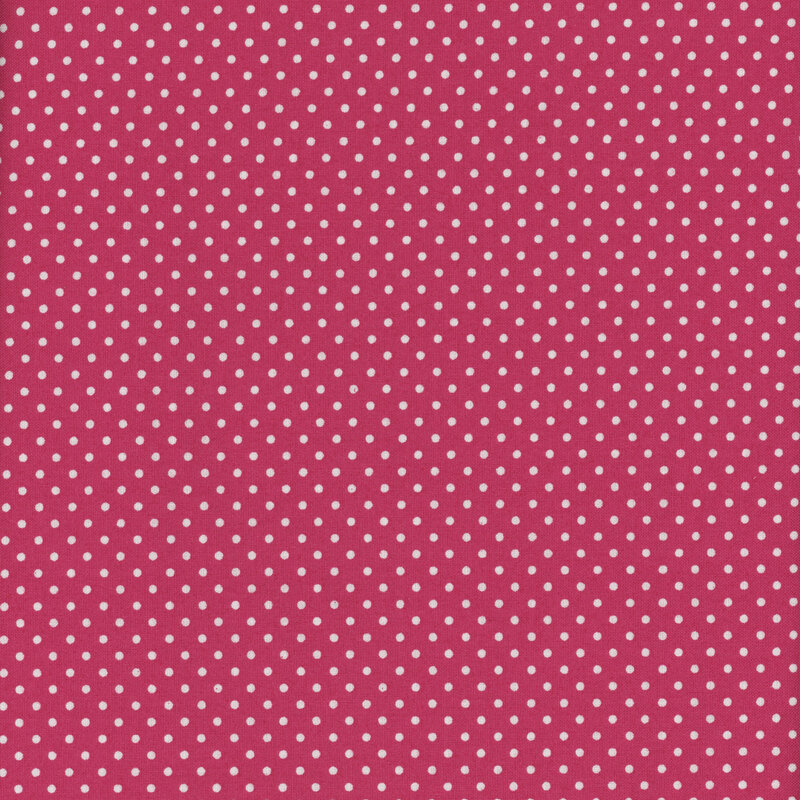 this fabric features a deep rosy pink background with ditsy white polka dots