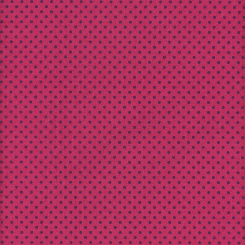 this fabric features an intense hot pink background with dark purple ditsy polka dots