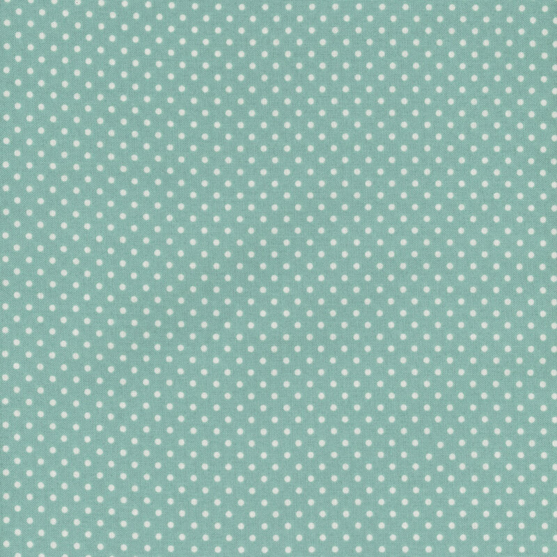 this fabric features a teal aqua background with ditsy white polka dots