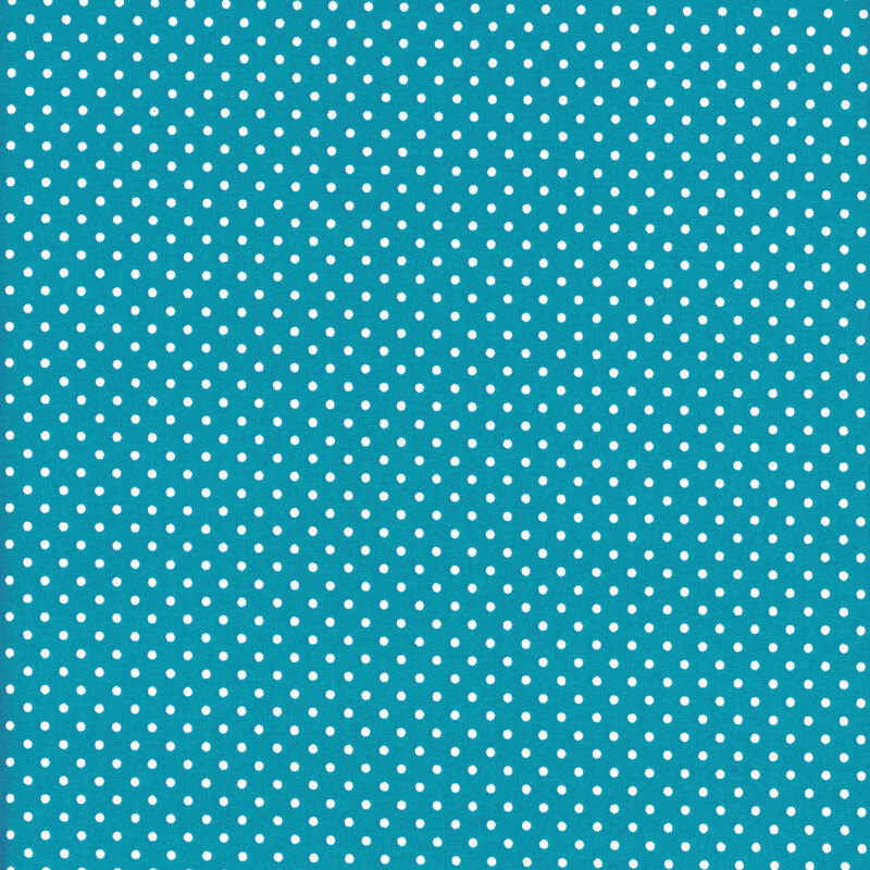 this fabric features a bold teal blue background with ditsy white polka dots