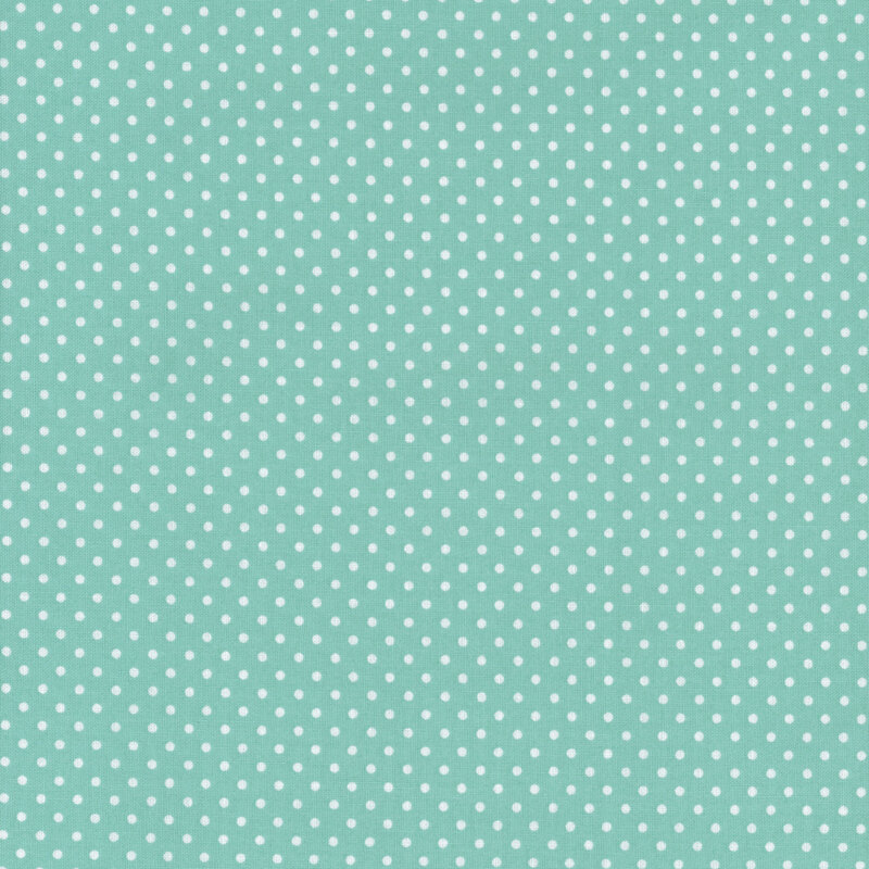 This fabric features a bright, bold teal blue background with ditsy white polka dots.