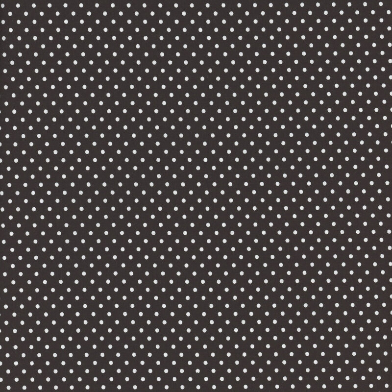 this fabric features a solid black background with bright white polka dots