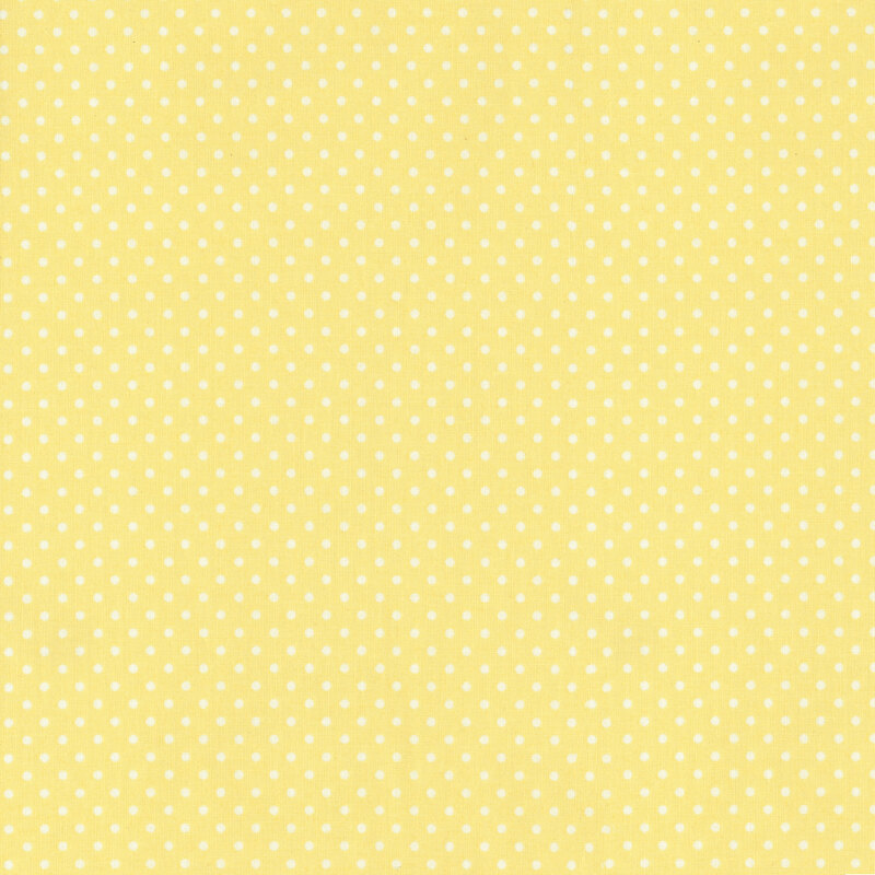 This fabric features a soft pastel yellow fabric with ditsy white polka dots