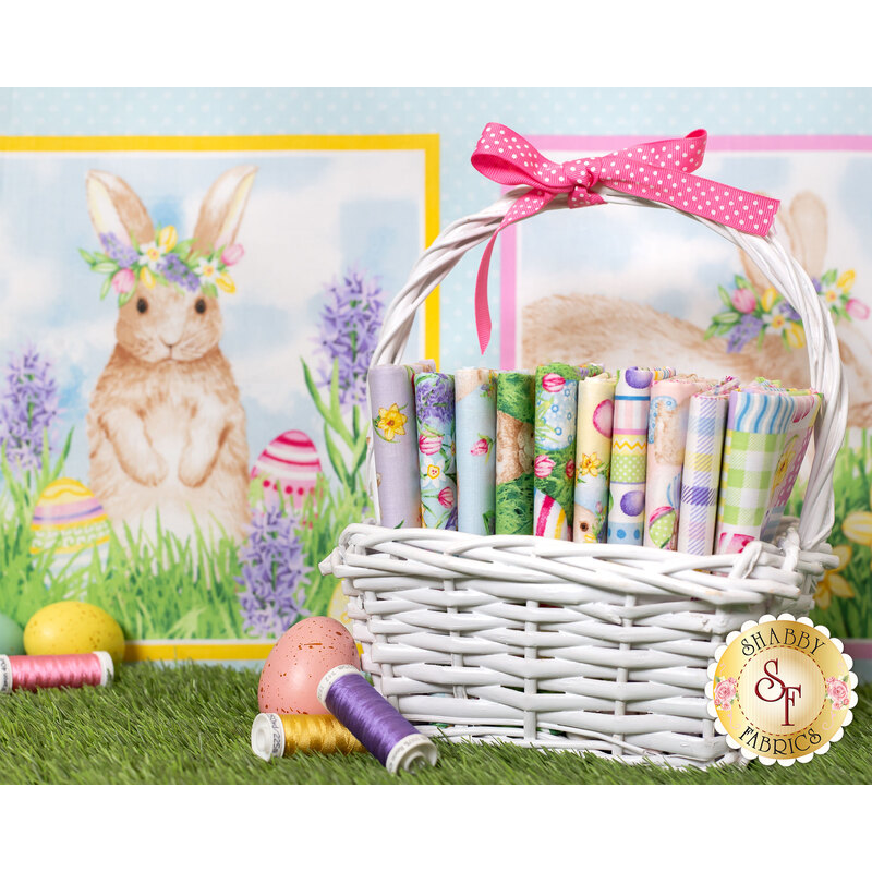 hoppy hunting panel behind a white basket full of pastel fabric with bunnies, flowers and easter eggs