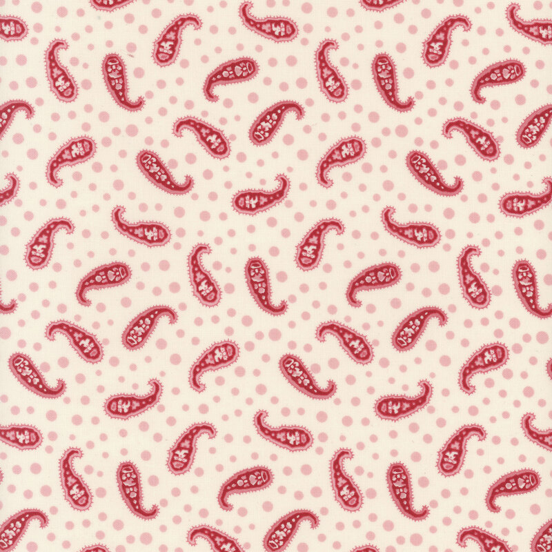 This fabric features red paisley motifs on a cream background with pink dots.