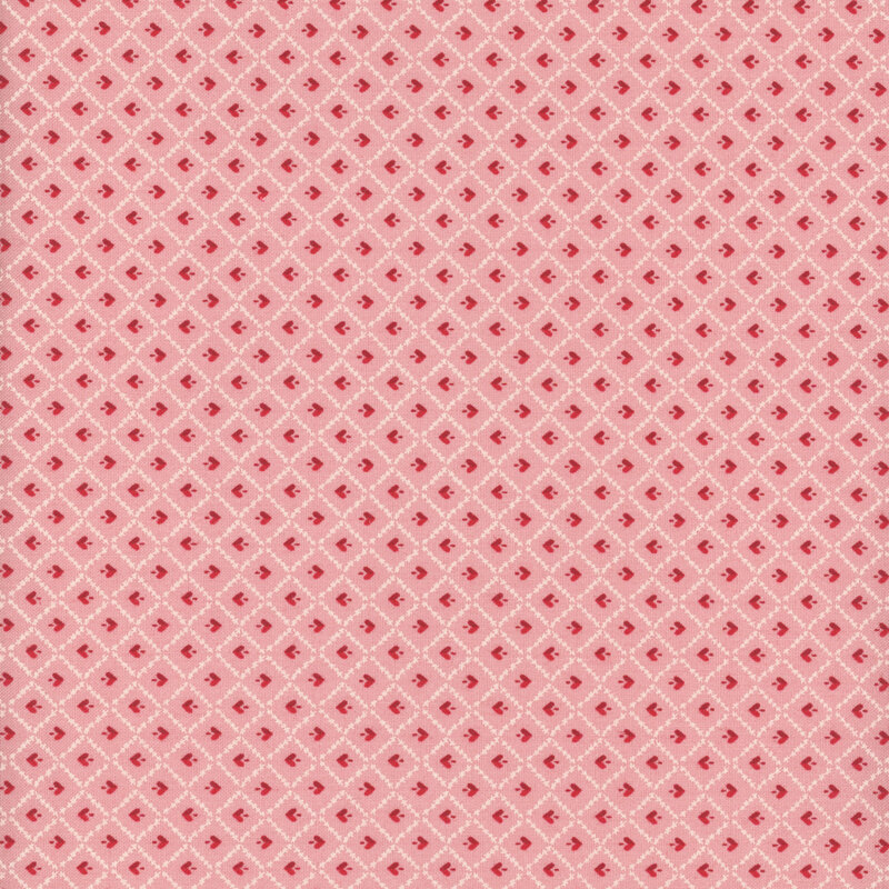 fabric featuring cream white lattice and red heart motifs on a lovely pink background