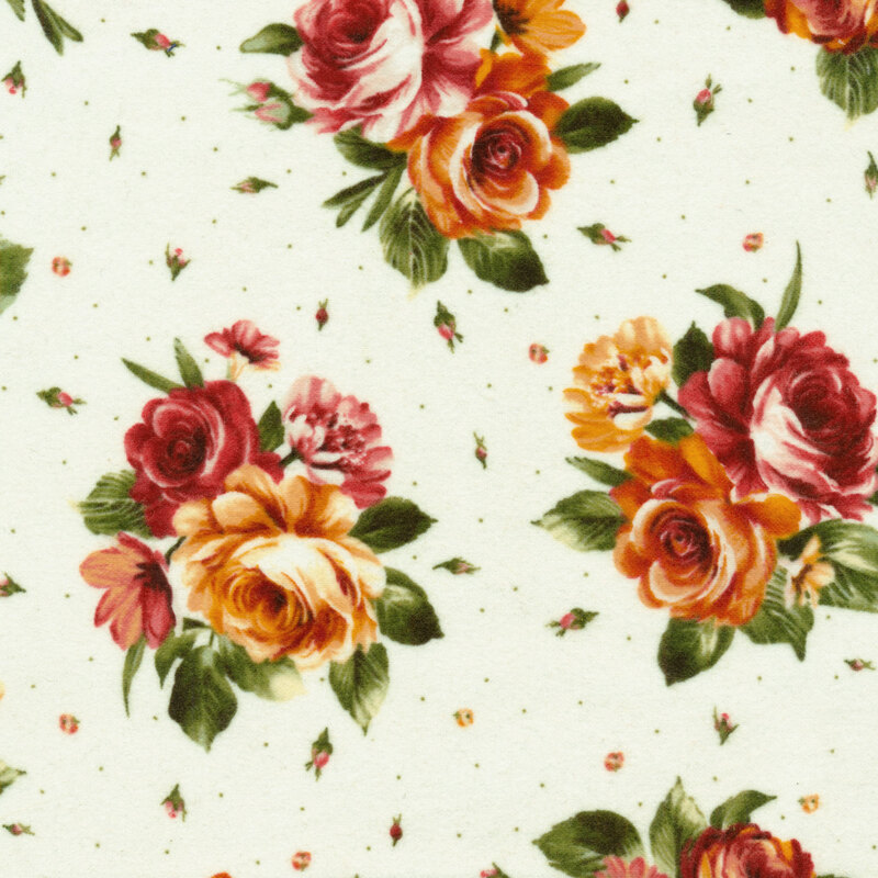 Cream fabric covered in rustic orange and red roses accented by warm green leaves and tiny scattered rose buds