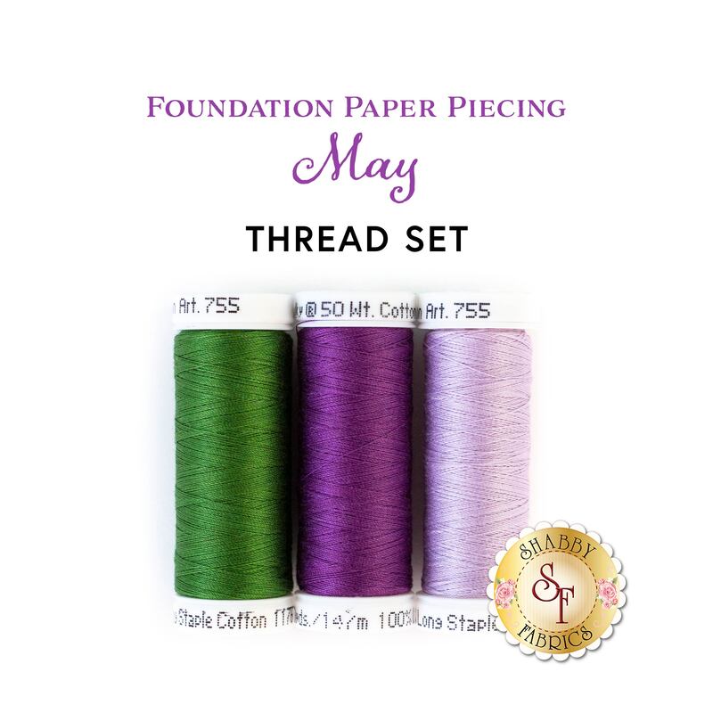 Three spools of thread in two shades of purple and green isolated on a white background with the words 