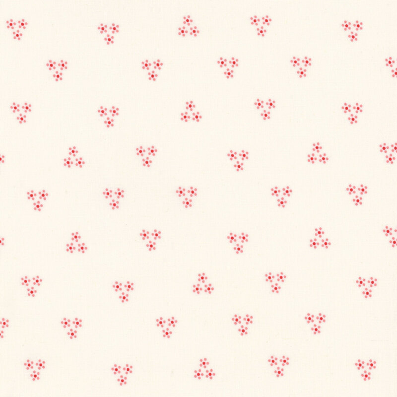 Image of fabric featuring clusters of flowers made out of groupings of small dots, set against a cream background