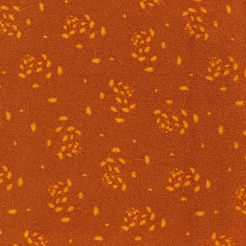 Dark orange fabric with scattered tonal flower clusters