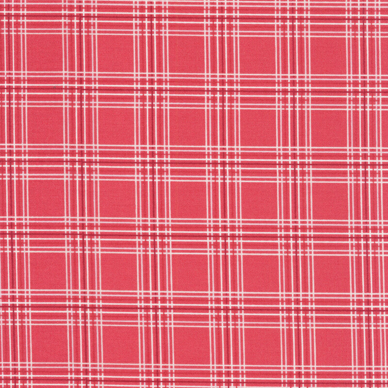 This fabric features a lovely thin-lined pink and cream plaid print on a faded red background