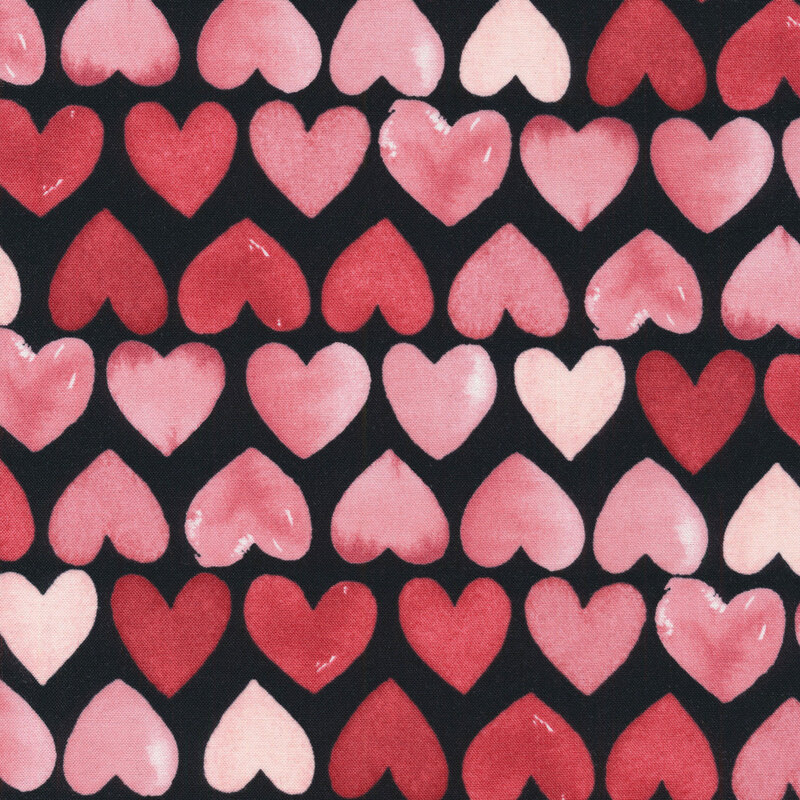 fabric featuring rows of watercolor pink and red hearts on a solid black background