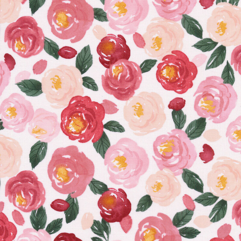 fabric featuring pink and cream watercolor roses with dark green leaves on a white background