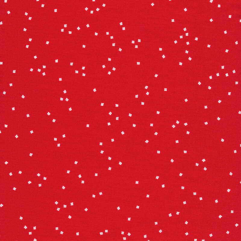 fabric with small white flower blossoms scattered on a red background
