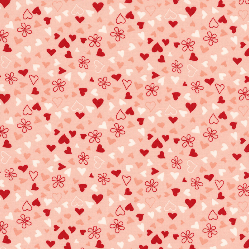 fabric featuring ditsy tossed red, cream and pink hearts on a light pink background