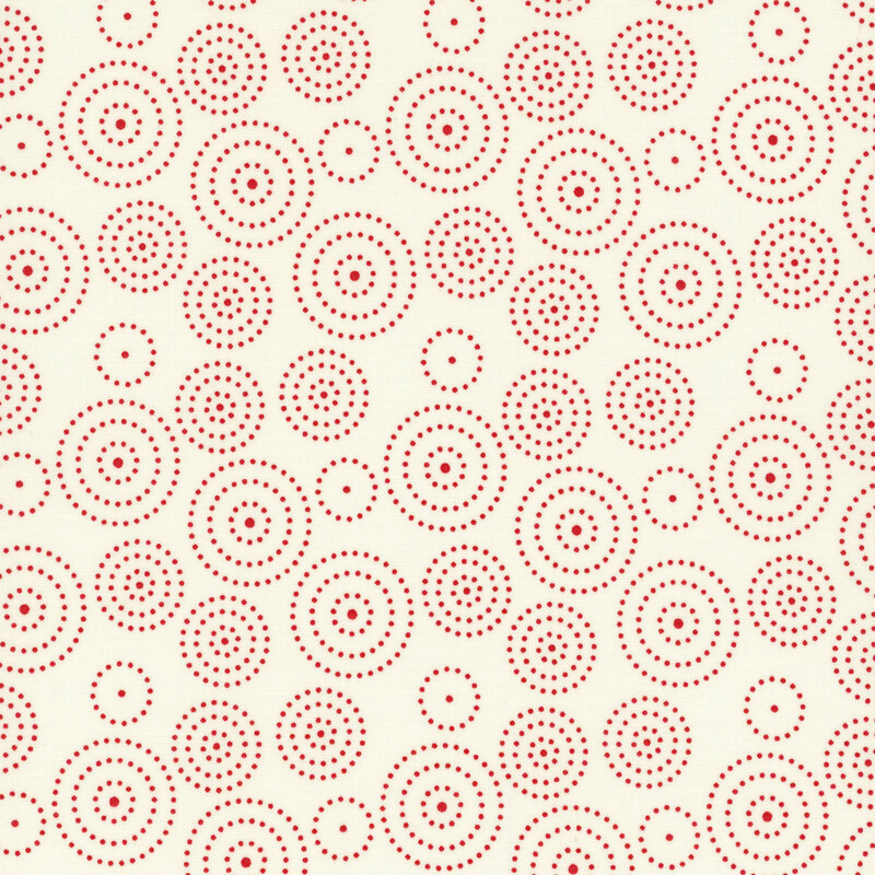 fabric featuring circles of various sizes composed of red dots on a solid cream background