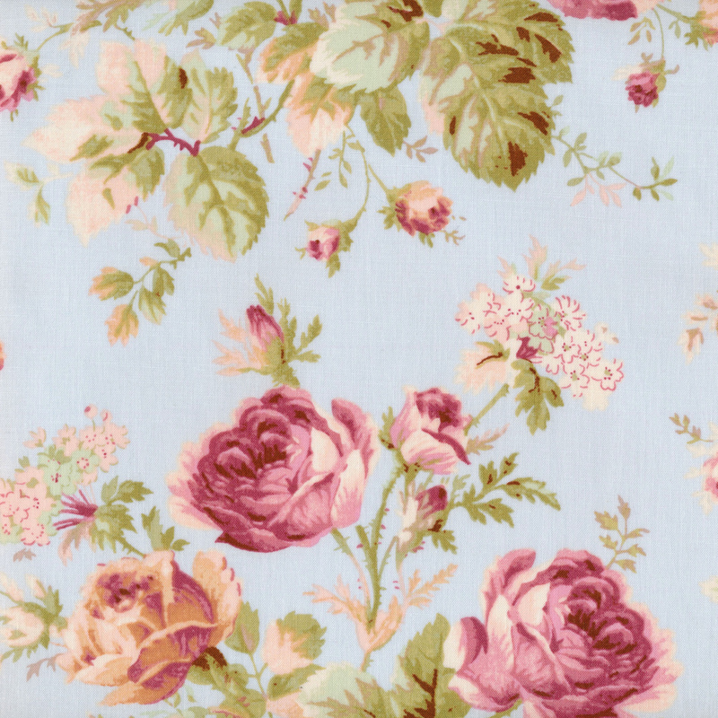 Image of fabric featuring large pink roses, leaves, and tiny beige wildflowers on a light blue background